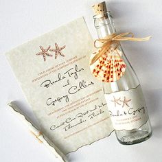 an empty bottle with a seashell in it next to a card and corkscrew