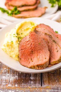 meatloaf with mashed potatoes and parsley on a white plate, ready to be eaten