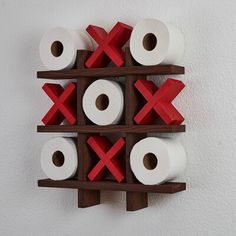 two wooden shelves holding several rolls of toilet paper