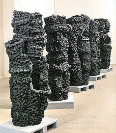 there are many black sculptures on display in the room