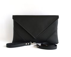 "Black Evening Clutch, Black leather Purse, Vegan Wristlet, Clutch Wristlet Wallet, Black Clutch Purse, Wallet Handbag, Wristlet Wallet   Create your own unique color composition: ✅ Model 1 https://www.etsy.com/ludamelnick/listing/700450757/custom-color-crossbody-purse-small?ref=shop_home_active_5&pro=1&frs=1 ✅ Model 2 https://www.etsy.com/listing/700440497/custom-crossbody-purse-gift-for-her?ref=shop_home_active_13&pro=1&frs=1Handmade clutch.  Handmade clutch. Made of vegan leather, fabric inside.  Details: Color - black. Pressbutton magnetic closure. There is one inside pocket. Vegan leather wrist strap. Vegan leather strap length - 115 cm (45\"). If you need another length just let us know. Approximate Dimensions: Width: 11.4\" (29 cm) Height: 7.5\" (19 cm) We hope you like what you see Initials Embroidery, Black Clutch Purse, Womens Clutch, Mom Black, Clutch Purse Black, Vegan Bag, Black Leather Clutch, Vegan Handbags, Vegan Leather Tote