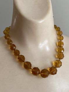 "Beautiful golden yellow citrine look crystal bead necklace that I matched with a pair of screwback earrings for a wonderful rich set to wear year round. Both pieces are fairly old, probably 50s or 60s and delicious. The necklace is just under 16\". Largest beads along the front probably 18 and 16mm which then get smaller near the clasp. Knotted between each bead so not stiff. Unique spring ring clasp which you will 'slide' open with a fingernail. It looks like a jeweler added a bit of silk wrap Crystal Beads Necklace, Graduated Pearl Necklace, Golden Crystal, Crystal Bead Necklace, Solid Perfume, Yellow Citrine, Faux Pearl Necklace, Silk Wrap, Faceted Crystal