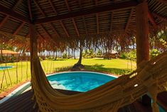 a hammock hanging over a swimming pool