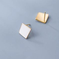 Make a statement with our sleek and stylish Geometric black white square stud earrings! Featuring a modern and eye-catching design, these earrings are the perfect addition to any outfit. The geometric shape adds a touch of uniqueness, while the black and white color combination effortlessly complements any style. Elevate your look and stand out from the crowd with these bold and elegant earrings. Materials: 925 sterling silverFinish: gold plate, enamelDimensions: 0.27 x 0.27 in Jewelry Care: See more information about how to care for your jewelry here. Shipping Policy: Orders will be shipped within 1-3 business days. Economy shipping will take 7-14 days to arrive and standard shipping is 1- 4 days for U.S. orders. International shipping time is depended on the country and per shipping meth Modern White Rectangular Jewelry, Modern White Geometric Earrings, Modern White Rectangular Earrings, Elegant Geometric White Jewelry, Elegant White Geometric Jewelry, White Rectangular Minimalist Jewelry, Minimalist White Rectangular Jewelry, Modern White Square Pendant Jewelry, Square White Earrings For Gift