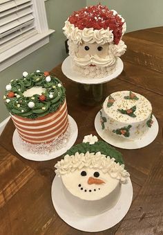 there are four cakes decorated to look like santa claus and snowmen on the table