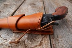 a brown leather case sitting on top of a wooden table