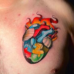 a man with a colorful heart tattoo on his chest