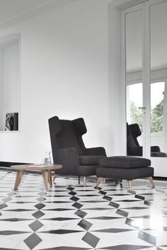 an elegant living room with black and white flooring