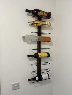 a wall mounted wine rack holding several bottles