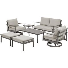 an outdoor furniture set with beige cushions and matching chairs, ottomans and coffee table