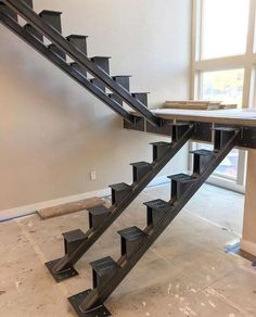 a set of metal stairs in an unfinished room