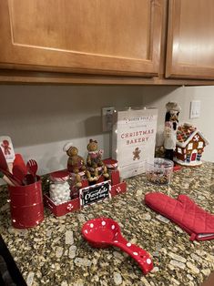 the kitchen counter is covered with christmas decorations and other holiday items, including red utensils