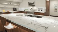 a kitchen with marble counter tops and wooden cabinets