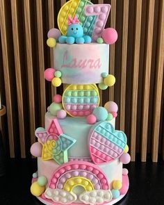 a three tiered cake with teddy bears on top