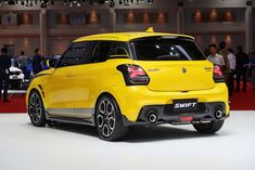 the suzuki swift is on display at an auto show