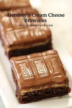 three brownies on a white plate with chocolate frosting and the words hershey's cream cheese brownies