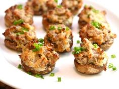 small appetizers on a white plate with green garnishes are ready to be eaten