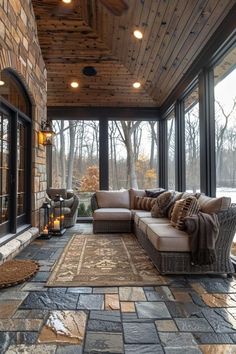 a living room filled with lots of furniture under a wooden ceiling covered in glass doors