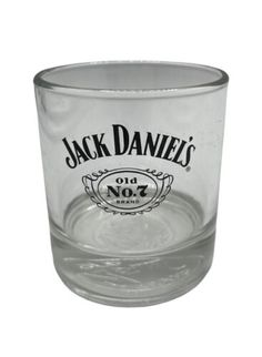 a glass cup with the name jack daniels on it's bottom and an image of a