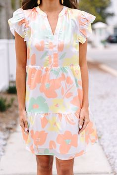 Bring a pop of spring style to any wardrobe with this At This Time Coral Orange Floral Dress. It's perfect for any warm weather occasion, with a cheerful pastel floral print and a cute, comfortable fit. Get ready to turn heads with this one-of-a-kind look. This dress features ruffled cap sleeves, a v-neckline, satin fabric, and a pastel floral print. 
Material has no amount of stretch.Sydney is wearing the small. Floral Satin Dress, Orange Floral Dress, Mint Julep Boutique, Coral Orange, Pastel Floral, Model Fits, Spring Style, Brown Floral, Satin Dress