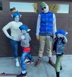 three adults and two children are dressed up as the same person in blue wigs