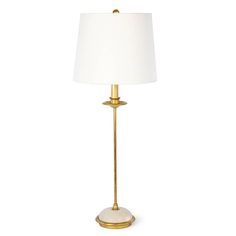 a gold lamp with a white shade on it