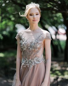 a woman in a dress is posing for the camera