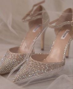 a pair of high heeled shoes with glitter on them