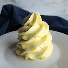 a white plate topped with sliced apples on top of a blue cloth covered tablecloth