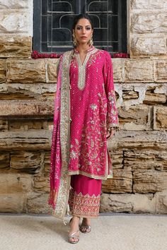 This fuschia cotton net worked kurta is the epitome of vintage charm with its zardoze and kamdani work and floral embroidery . The piece is paired with a silk kamdani chunri dupatta finished with ari borders. Wear it with a matching handworked Izaar. Semi-stitched Raw Silk Kurta With Dabka Work, Semi-stitched Pink Lawn Suit With Dabka Work, Semi-stitched Chanderi Sharara With Dabka, Transitional Traditional Wear With Dabka Work On Raw Silk, Eid Traditional Wear With Dabka Work In Raw Silk, Eid Raw Silk Traditional Wear With Dabka Work, Eid Chanderi Kurta With Dabka Work, Pink Traditional Wear With Resham Embroidery, Straight Churidar With Chikankari Embroidery In Chinon