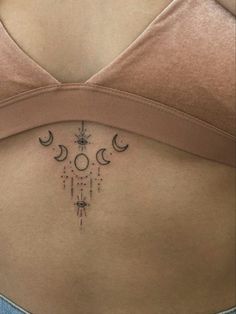 a woman's stomach with the moon and stars on it