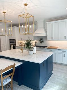 a large kitchen with an island in the middle and two chairs at the counter top