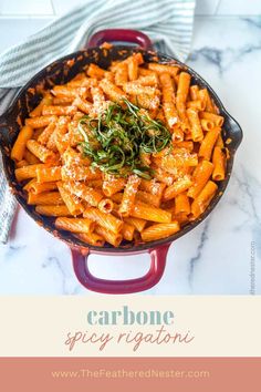 a red skillet filled with pasta and topped with parmesan cheese