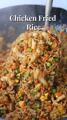 chicken fried rice with peas and carrots in a pan