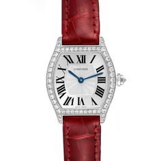 Cartier Tortue 18k White Gold Diamond Ladies Watch WA501007. Manual winding movement. 18K white gold case 24.0 x 30.0 mm. Octagonal crown set with a diamond. Diamond lugs. 18K white gold bezel with factory Cartier diamonds. Scratch resistant sapphire crystal. Silver dial with Roman numerals. Blue sword shape hands. Secret signature at VII. Red leather strap with 18k white gold deployant buckle. Cartier Silver, 1950s Mens, Gold Case, Women Wrist Watch, Ladies Watch, Roman Numerals, Silver Diamonds, Sapphire Crystal, White Gold Diamonds