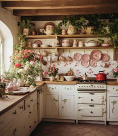 a kitchen filled with lots of pots and pans on top of a stove top oven