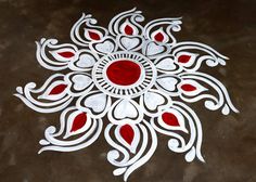 a white and red design on the ground with hearts in it's center,