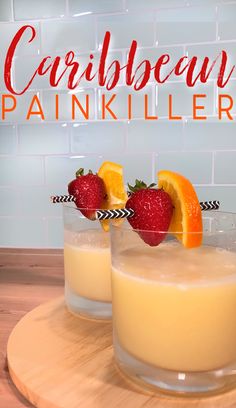 two glasses filled with orange juice and strawberries