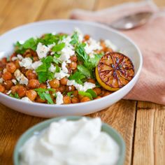 a white bowl filled with food on top of a wooden table