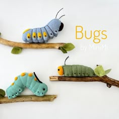 three caterpillars sitting on top of wooden sticks with the words bugs by minimi written above them