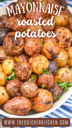 a plate full of cooked potatoes on a blue and white table cloth with the words, mayonnaise roasted potatoes