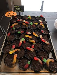 cupcakes are arranged in the shape of candy and candies on top of dirt