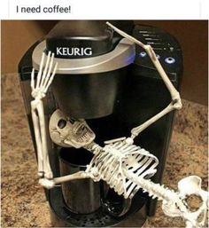 a coffee maker with skeleton figurines on it