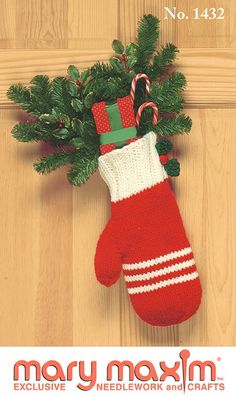 a knitted christmas stocking with candy canes hanging from it