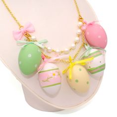 Details:-19" total necklace length-2" length chunky Charms-Choose Gold or Silver finish chain-Accented with high quality glass pearls-Finished with a pastel pink gingham bow-Charms include large pastel hollow decorated Easter egg with satin bows in different designs-Handmade and Limited-Large but very lightweightMatching earrings available in my shop!*Eggs may have small flaws in the paint**Made to order - may take up to 2 weeks to make before shipment**Every order comes with free gift packaging Collar Ideas, Easter Necklace, Pink Statement Necklace, Holiday Clothes, Gold Statement Necklace, Gold Charm Necklace, Easter Egg Decorating, Enamel Lapel Pin, Valentines Necklace