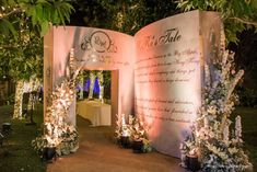 an outdoor ceremony with flowers and lights on the walls, decorated in pink hues