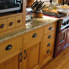 a kitchen with wooden cabinets and granite counter tops