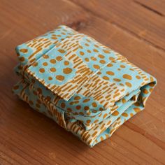 a folded piece of cloth sitting on top of a wooden table