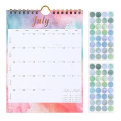 a calendar with the word july on it next to some stickers and a clipboard