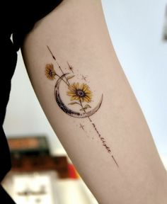 a woman's arm with a sunflower and moon tattoo on the left forearm